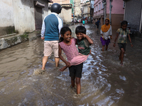 Residents of Kathmandu are wading through the floodwater along the embankment of the Bagmati River flowing through the capital after incessa...