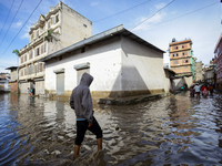 A Nepali man is wading through the flooded water in Nepal on July 31, 2024. (