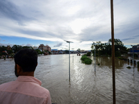 Nepali citizens are watching the rising level of Bagmati River in Kathmandu, Nepal, on July 31, 2024. (