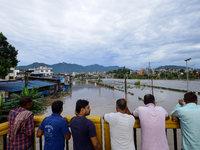 Nepali citizens are watching the rising level of Bagmati River in Kathmandu, Nepal, on July 31, 2024. (