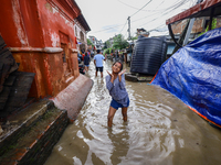 People are wading through the flood in a slum in Kathmandu, Nepal, on July 31, 2024. (