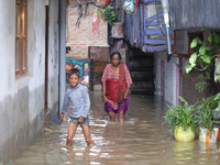 People are wading through the flood in a slum in Kathmandu, Nepal, on July 31, 2024. (