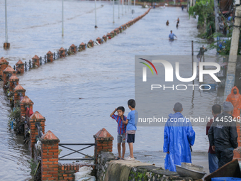 Nepali citizens are watching the rising level of Bagmati River in Kathmandu, Nepal, on July 31, 2024. (