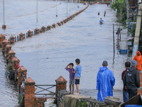 Nepali citizens are watching the rising level of Bagmati River in Kathmandu, Nepal, on July 31, 2024. (