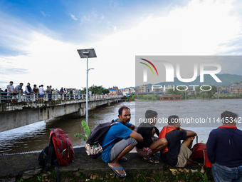 Nepali citizens are watching the rising level of Bagmati River in Kathmandu, Nepal, on July 31, 2024. (