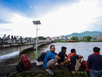 Nepali citizens are watching the rising level of Bagmati River in Kathmandu, Nepal, on July 31, 2024. (