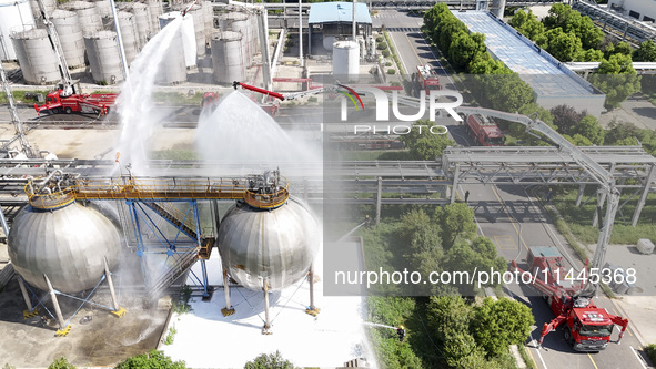 Firefighters are performing a rescue drill at a chemical plant amid high temperatures in Huai'an, China, on July 31, 2024. 