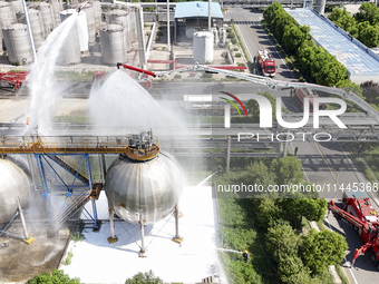 Firefighters are performing a rescue drill at a chemical plant amid high temperatures in Huai'an, China, on July 31, 2024. (