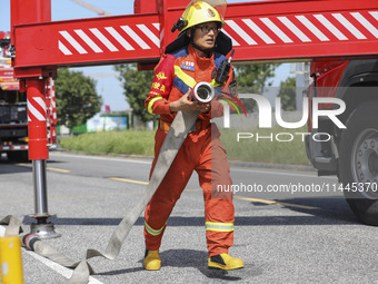 Firefighters are performing a rescue drill at a chemical plant amid high temperatures in Huai'an, China, on July 31, 2024. (