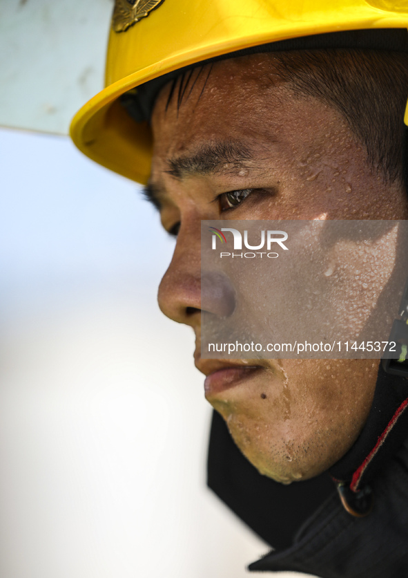 Firefighters are performing a rescue drill at a chemical plant amid high temperatures in Huai'an, China, on July 31, 2024. 