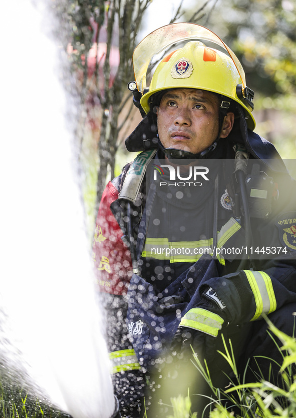 Firefighters are performing a rescue drill at a chemical plant amid high temperatures in Huai'an, China, on July 31, 2024. 