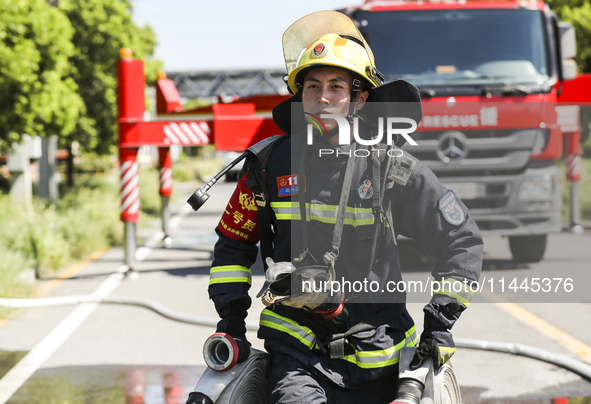 Firefighters are performing a rescue drill at a chemical plant amid high temperatures in Huai'an, China, on July 31, 2024. 