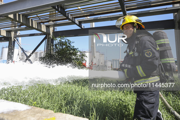 Firefighters are performing a rescue drill at a chemical plant amid high temperatures in Huai'an, China, on July 31, 2024. 