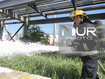 Firefighters are performing a rescue drill at a chemical plant amid high temperatures in Huai'an, China, on July 31, 2024. (