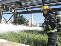 Firefighters are performing a rescue drill at a chemical plant amid high temperatures in Huai'an, China, on July 31, 2024. (