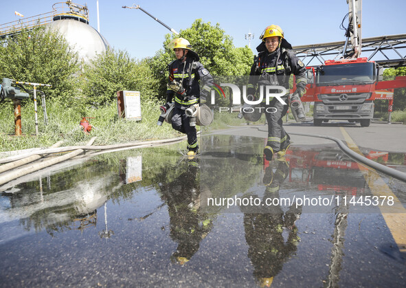 Firefighters are performing a rescue drill at a chemical plant amid high temperatures in Huai'an, China, on July 31, 2024. 