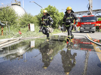 Firefighters are performing a rescue drill at a chemical plant amid high temperatures in Huai'an, China, on July 31, 2024. (