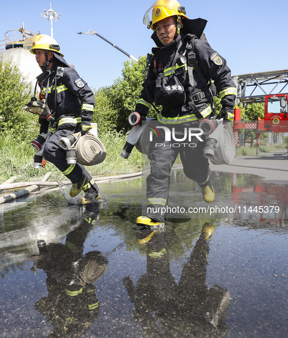 Firefighters are performing a rescue drill at a chemical plant amid high temperatures in Huai'an, China, on July 31, 2024. 