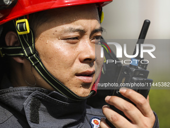 Firefighters are performing a rescue drill at a chemical plant amid high temperatures in Huai'an, China, on July 31, 2024. (