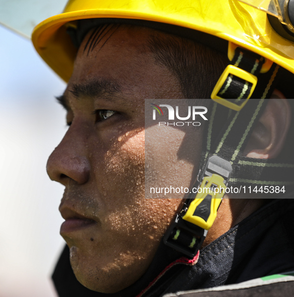 Firefighters are performing a rescue drill at a chemical plant amid high temperatures in Huai'an, China, on July 31, 2024. 