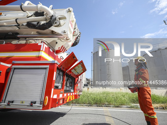 Firefighters are performing a rescue drill at a chemical plant amid high temperatures in Huai'an, China, on July 31, 2024. (