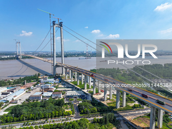 Construction workers are carrying out asphalt paving on the south approach bridge of Longtan Yangtze River Bridge in Nanjing, China, on July...