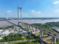 Construction workers are carrying out asphalt paving on the south approach bridge of Longtan Yangtze River Bridge in Nanjing, China, on July...