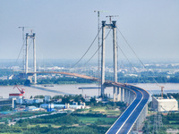 Construction workers are carrying out asphalt paving on the south approach bridge of Longtan Yangtze River Bridge in Nanjing, China, on July...