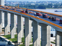 Construction workers are carrying out asphalt paving on the south approach bridge of Longtan Yangtze River Bridge in Nanjing, China, on July...