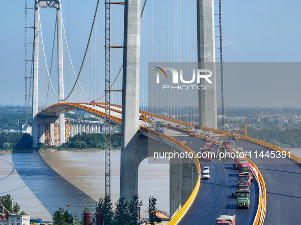 Construction workers are carrying out asphalt paving on the south approach bridge of Longtan Yangtze River Bridge in Nanjing, China, on July...