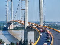 Construction workers are carrying out asphalt paving on the south approach bridge of Longtan Yangtze River Bridge in Nanjing, China, on July...