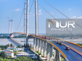 Construction workers are carrying out asphalt paving on the south approach bridge of Longtan Yangtze River Bridge in Nanjing, China, on July...