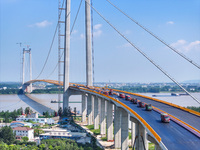 Construction workers are carrying out asphalt paving on the south approach bridge of Longtan Yangtze River Bridge in Nanjing, China, on July...