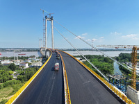 Construction workers are carrying out asphalt paving on the south approach bridge of Longtan Yangtze River Bridge in Nanjing, China, on July...