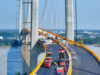 Construction workers are carrying out asphalt paving on the south approach bridge of Longtan Yangtze River Bridge in Nanjing, China, on July...