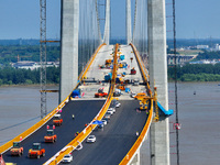 Construction workers are carrying out asphalt paving on the south approach bridge of Longtan Yangtze River Bridge in Nanjing, China, on July...