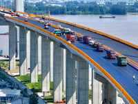 Construction workers are carrying out asphalt paving on the south approach bridge of Longtan Yangtze River Bridge in Nanjing, China, on July...