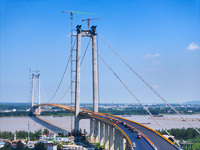 Construction workers are carrying out asphalt paving on the south approach bridge of Longtan Yangtze River Bridge in Nanjing, China, on July...