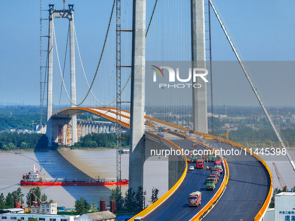 Construction workers are carrying out asphalt paving on the south approach bridge of Longtan Yangtze River Bridge in Nanjing, China, on July...