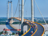 Construction workers are carrying out asphalt paving on the south approach bridge of Longtan Yangtze River Bridge in Nanjing, China, on July...