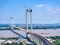 Construction workers are carrying out asphalt paving on the south approach bridge of Longtan Yangtze River Bridge in Nanjing, China, on July...