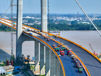 Construction workers are carrying out asphalt paving on the south approach bridge of Longtan Yangtze River Bridge in Nanjing, China, on July...