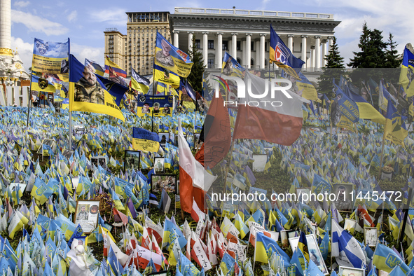 Polish flags are appearing among Ukrainian flags at the makeshift memorial in honor of the Ukrainian Armed Forces soldiers who are dying in...