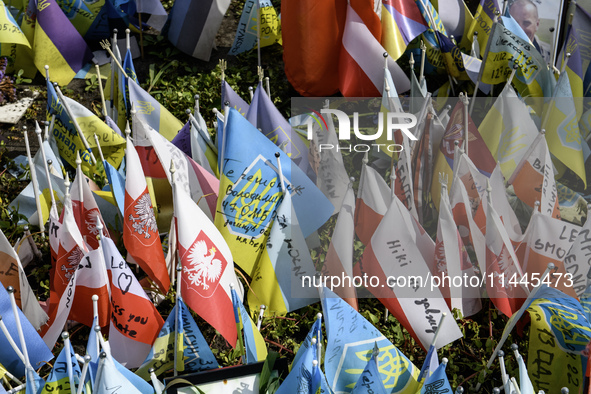 Polish flags are appearing among Ukrainian flags at the makeshift memorial in honor of the Ukrainian Armed Forces soldiers who are dying in...