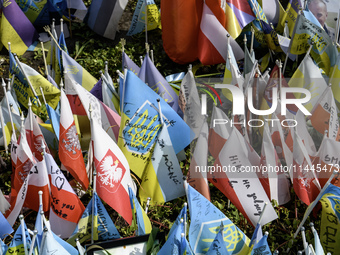 Polish flags are appearing among Ukrainian flags at the makeshift memorial in honor of the Ukrainian Armed Forces soldiers who are dying in...