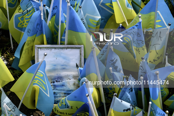 Portraits are fading in the sun at a makeshift memorial in honor of the Ukrainian Armed Forces soldiers who died in battles with Russian tro...