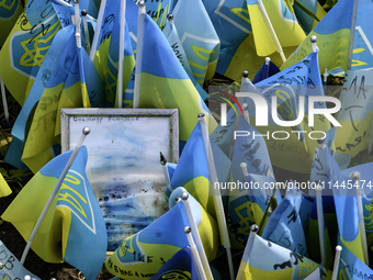 Portraits are fading in the sun at a makeshift memorial in honor of the Ukrainian Armed Forces soldiers who died in battles with Russian tro...