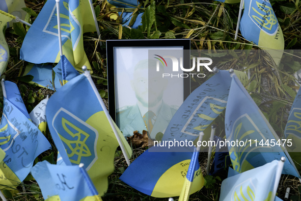 Portraits are fading in the sun at a makeshift memorial in honor of the Ukrainian Armed Forces soldiers who died in battles with Russian tro...