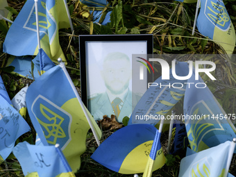 Portraits are fading in the sun at a makeshift memorial in honor of the Ukrainian Armed Forces soldiers who died in battles with Russian tro...