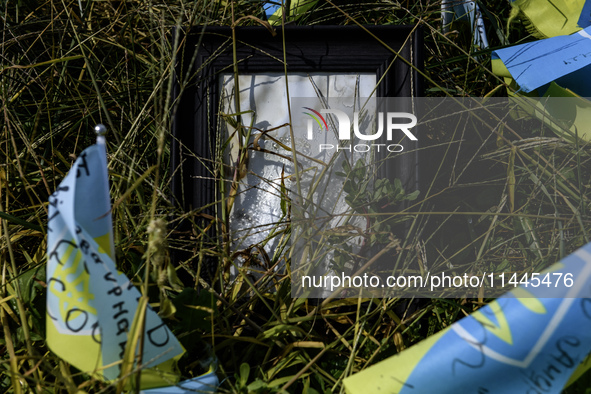 Portraits are fading in the sun at a makeshift memorial in honor of the Ukrainian Armed Forces soldiers who died in battles with Russian tro...